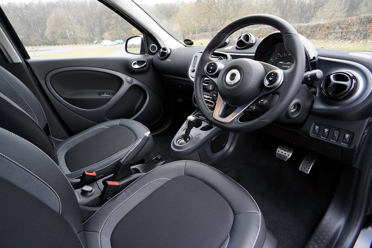 Explore the sleek and modern design of this luxury car interior featuring leather seats and advanced technology.